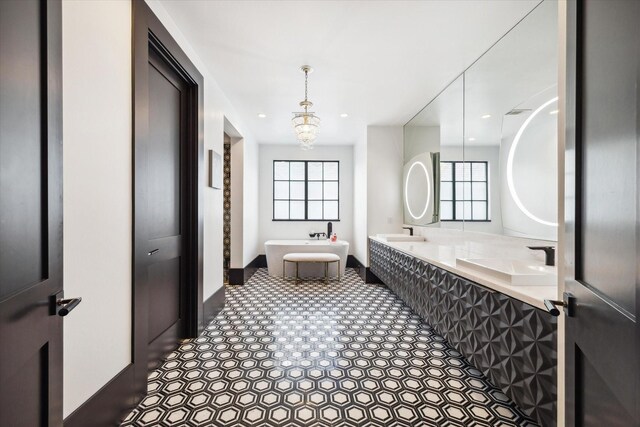 3835 Olympia Dr, Houston, TX 77019 - bathroom featuring a freestanding bath, plenty of natural light, baseboards, recessed lighting, and double vanity
