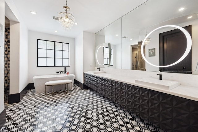 3835 Olympia Dr, Houston, TX 77019 - bathroom with a freestanding bath, recessed lighting, double vanity, and a chandelier