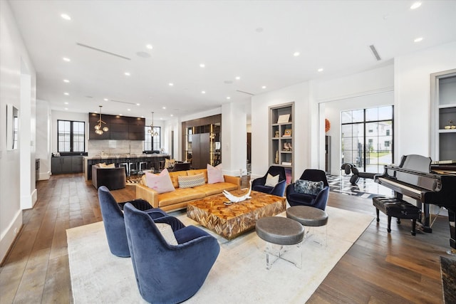 3835 Olympia Dr, Houston, TX 77019 - living room with wood-type flooring, recessed lighting, baseboards, and built in features