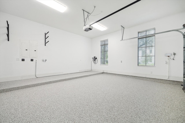 3835 Olympia Dr, Houston, TX 77019 - garage featuring a garage door opener and baseboards