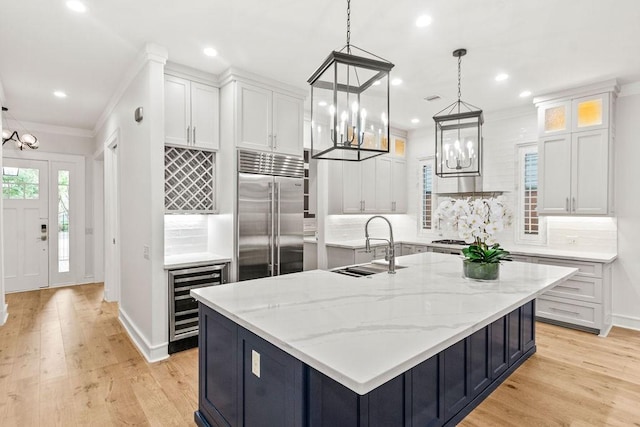 1024 Waverly St, Houston, TX 77008 - kitchen featuring built in refrigerator, beverage cooler, a chandelier, white cabinetry, and recessed lighting