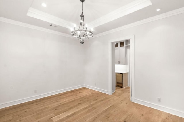 1024 Waverly St, Houston, TX 77008 - spare room with a raised ceiling, a chandelier, crown molding, light wood-style floors, and baseboards