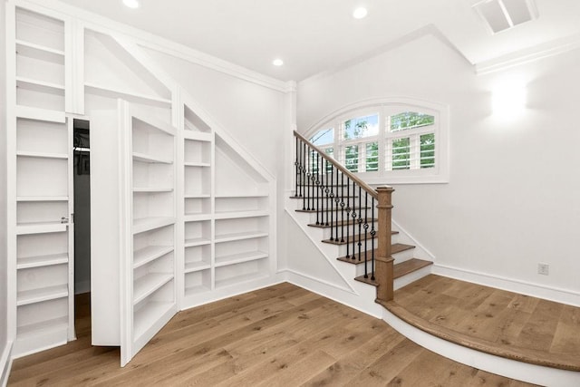 1024 Waverly St, Houston, TX 77008 - staircase featuring wood finished floors, built in features, and recessed lighting
