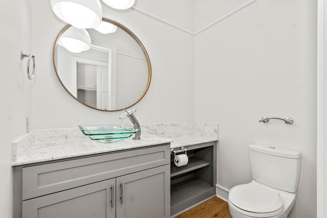 1024 Waverly St, Houston, TX 77008 - half bathroom featuring vanity, toilet, and wood finished floors