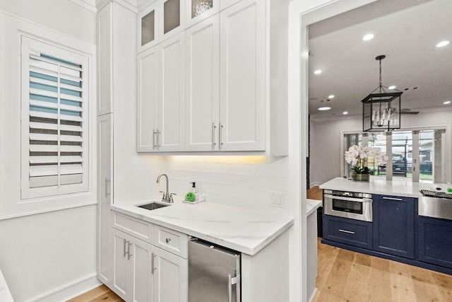 1024 Waverly St, Houston, TX 77008 - indoor wet bar with stainless steel oven, light wood-type flooring, refrigerator, recessed lighting, and a chandelier