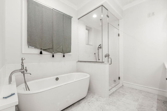 1024 Waverly St, Houston, TX 77008 - bathroom with ornamental molding, a shower stall, a freestanding tub, and marble look tile flooring
