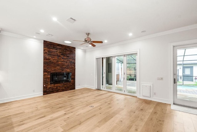 1024 Waverly St, Houston, TX 77008 - unfurnished living room with light wood-style flooring, a ceiling fan, crown molding, a large fireplace, and recessed lighting