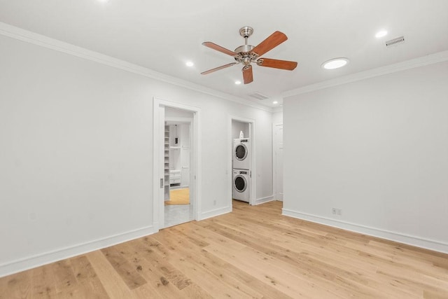 1024 Waverly St, Houston, TX 77008 - unfurnished bedroom with stacked washing machine and dryer, recessed lighting, light wood finished floors, ornamental molding, and ensuite bath