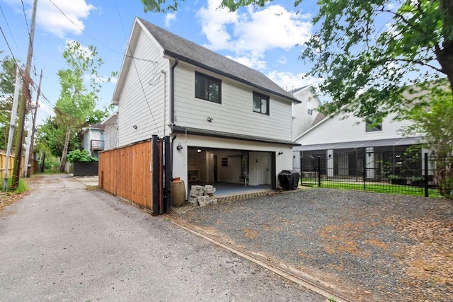 1024 Waverly St, Houston, TX 77008 - view of front of house with gravel driveway, fence, and a garage