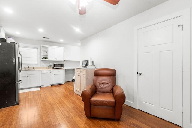 1024 Waverly St, Houston, TX 77008 - kitchen featuring stainless steel appliances, light wood-style floors, a ceiling fan, light countertops, and open shelves