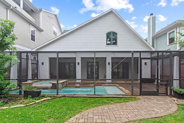 1024 Waverly St, Houston, TX 77008 - back of property featuring a pool with connected hot tub, glass enclosure, a patio area, and a yard