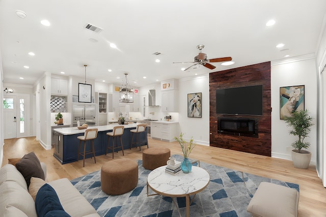 1024 Waverly St, Houston, TX 77008 - living area with light wood finished floors, ornamental molding, a ceiling fan, recessed lighting, and baseboards