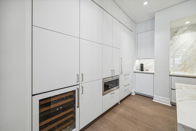 bar featuring wine cooler, recessed lighting, and light wood-type flooring