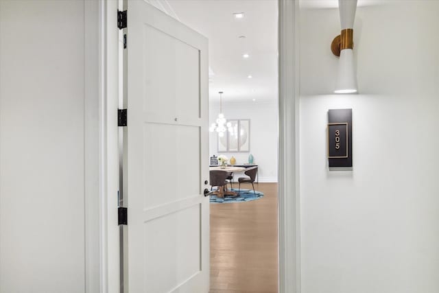hall with wood finished floors, baseboards, and recessed lighting