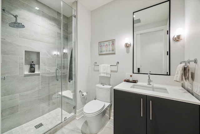 full bathroom with vanity, a stall shower, baseboards, and toilet