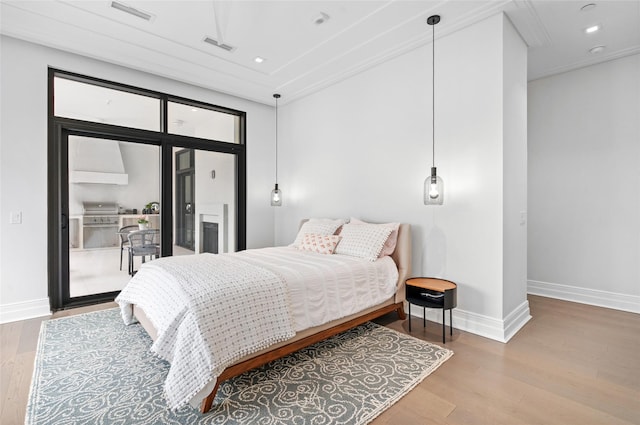 bedroom with recessed lighting, access to outside, visible vents, and wood finished floors