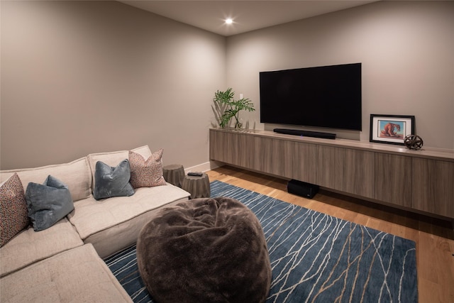 living area featuring baseboards, recessed lighting, and wood finished floors