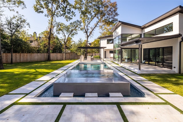 view of swimming pool featuring a jacuzzi, a fenced backyard, a fenced in pool, a patio, and a yard