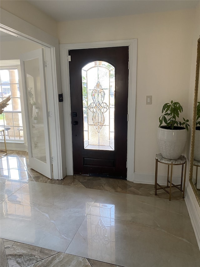 1319 Cherry Spring Dr, Houston, TX 77038 - foyer entrance featuring marble finish floor, baseboards, and a healthy amount of sunlight