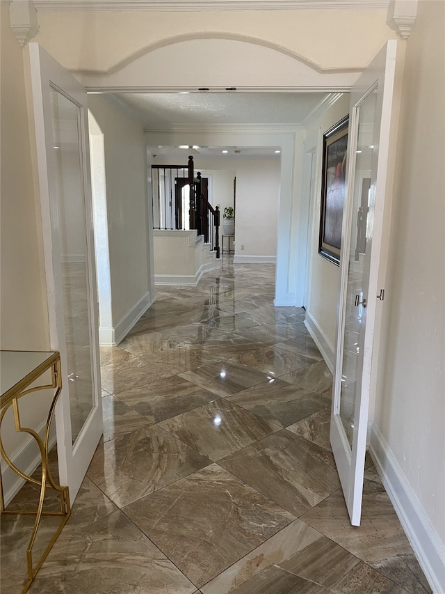1319 Cherry Spring Dr, Houston, TX 77038 - hallway with marble finish floor, ornamental molding, and baseboards