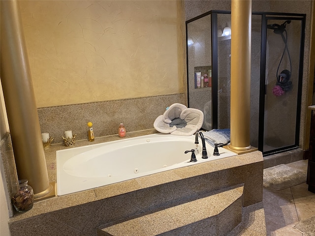 1319 Cherry Spring Dr, Houston, TX 77038 - full bathroom featuring decorative columns, a shower stall, a tub with jets, tile patterned flooring, and a textured wall