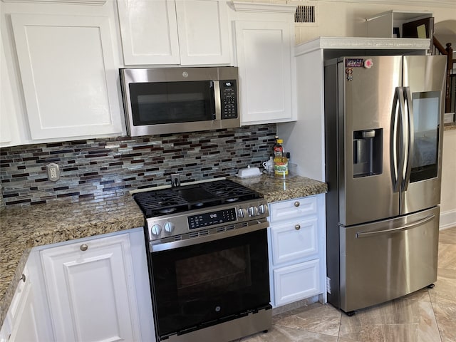 1319 Cherry Spring Dr, Houston, TX 77038 - kitchen with white cabinetry, backsplash, light stone countertops, and appliances with stainless steel finishes