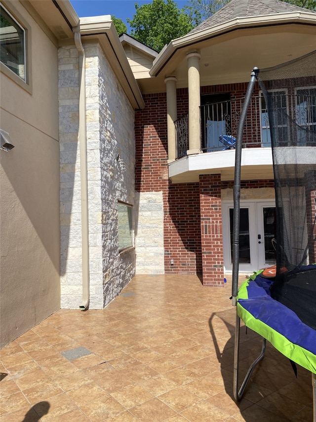1319 Cherry Spring Dr, Houston, TX 77038 - view of patio with a balcony and french doors