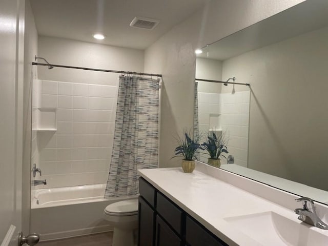 full bathroom with vanity, toilet, visible vents, shower / bath combo, and wood finished floors