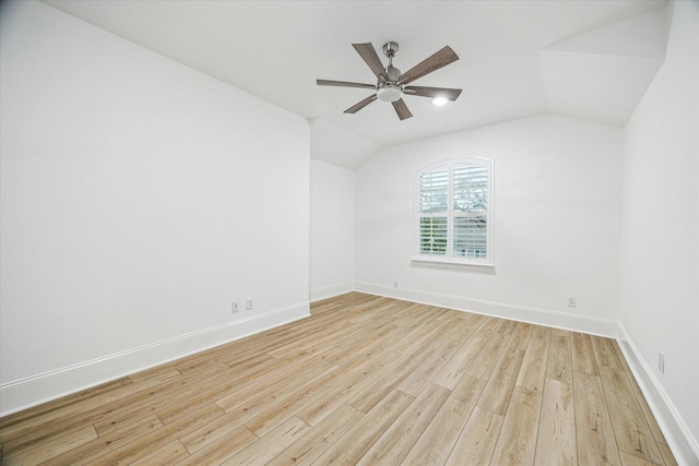 unfurnished room featuring light wood-style floors, baseboards, a ceiling fan, and lofted ceiling