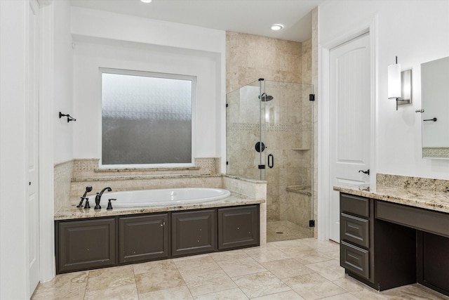 bathroom with a shower stall, vanity, and a garden tub