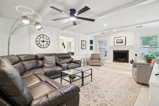 5306 Havenwoods Dr, Houston, TX 77066 - living room with beamed ceiling, a ceiling fan, a decorative wall, a brick fireplace, and tile patterned flooring