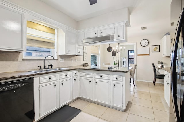 5306 Havenwoods Dr, Houston, TX 77066 - kitchen with black appliances, under cabinet range hood, a sink, and white cabinets