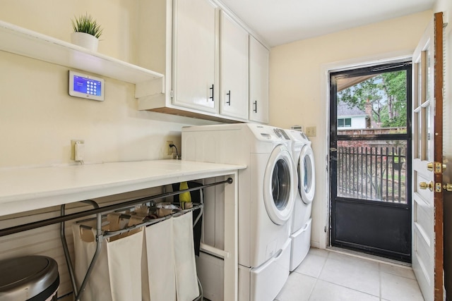 5306 Havenwoods Dr, Houston, TX 77066 - washroom with cabinet space, separate washer and dryer, and light tile patterned floors