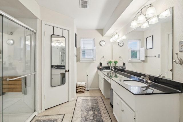 5306 Havenwoods Dr, Houston, TX 77066 - bathroom featuring double vanity, plenty of natural light, tile patterned floors, and a stall shower