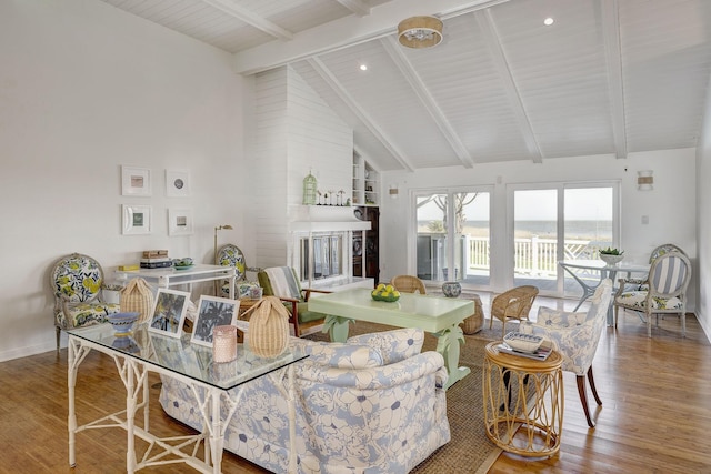 living room featuring wood finished floors, high vaulted ceiling, beamed ceiling, and baseboards