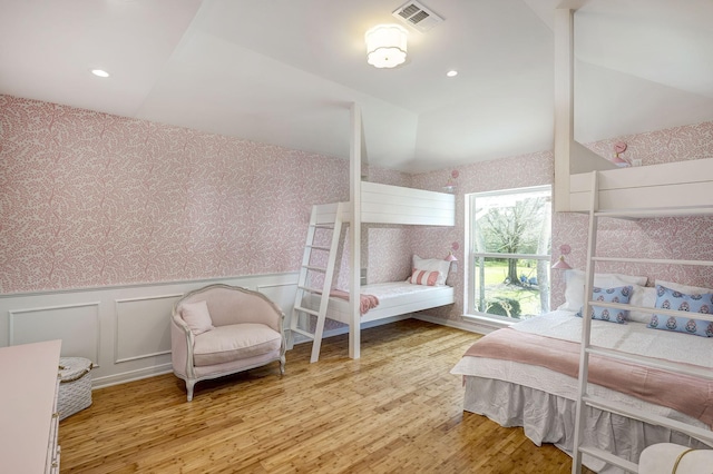 bedroom featuring wallpapered walls, wood finished floors, a wainscoted wall, and recessed lighting