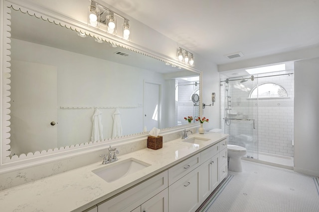 full bath with toilet, a stall shower, and double vanity