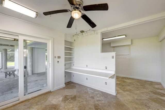 bathroom featuring ceiling fan and baseboards