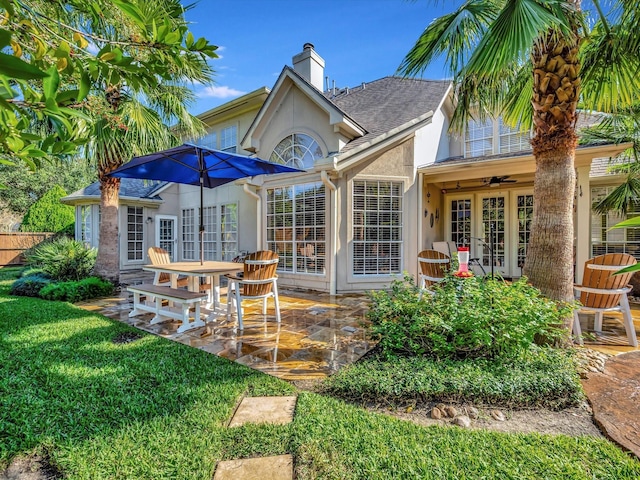 15415 Parkwood Way, Houston, TX 77059 - rear view of property featuring a patio area, a yard, a chimney, stucco siding, and french doors