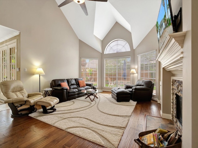 15415 Parkwood Way, Houston, TX 77059 - living area featuring a fireplace, a ceiling fan, baseboards, and hardwood / wood-style flooring