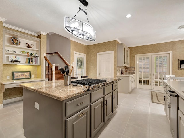 15415 Parkwood Way, Houston, TX 77059 - kitchen featuring light tile patterned floors, stainless steel gas cooktop, a center island, french doors, and gray cabinetry