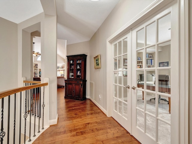 15415 Parkwood Way, Houston, TX 77059 - hall featuring visible vents, an upstairs landing, wood finished floors, french doors, and lofted ceiling