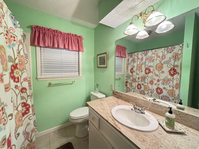 full bathroom featuring toilet, vanity, tile patterned floors, and a textured ceiling