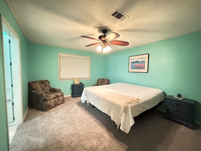 carpeted bedroom featuring baseboards, a ceiling fan, visible vents, and a textured ceiling