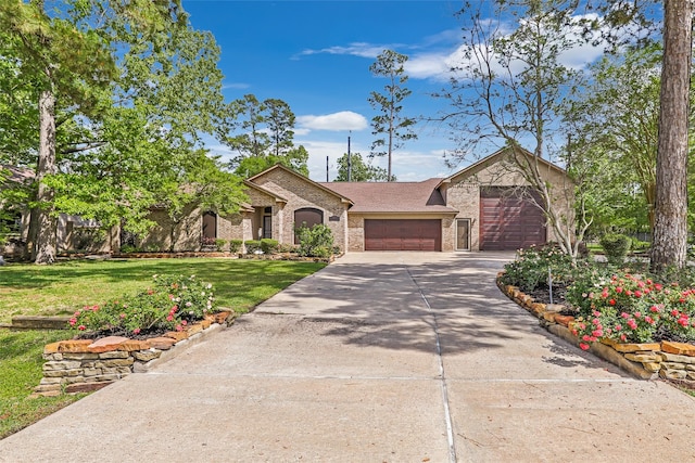 18510 Bluffview Dr, Crosby, TX 77532 - view of front facade with a garage, a front lawn, stone siding, brick siding, and concrete driveway