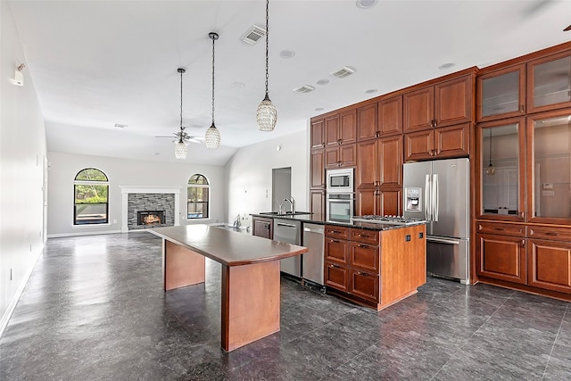 18510 Bluffview Dr, Crosby, TX 77532 - kitchen with visible vents, dark countertops, a center island with sink, a ceiling fan, and appliances with stainless steel finishes