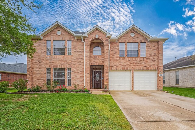 traditional home featuring a front lawn, an attached garage, brick siding, and concrete driveway
