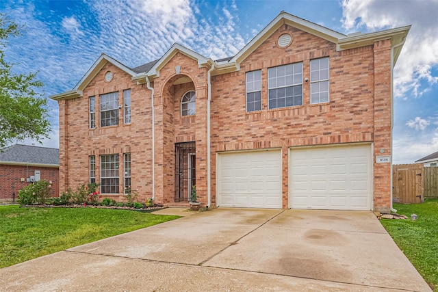 view of front of property with fence, an attached garage, concrete driveway, a front yard, and brick siding