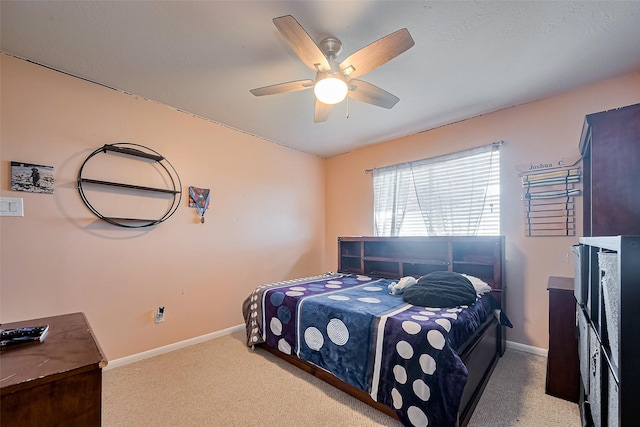 carpeted bedroom featuring baseboards and ceiling fan