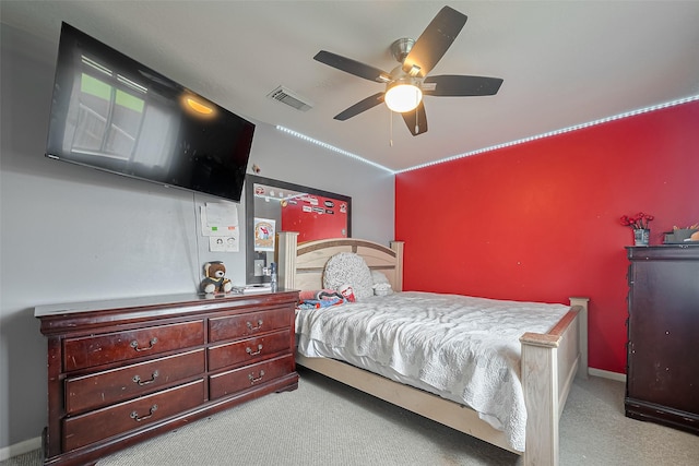 carpeted bedroom featuring baseboards, visible vents, and a ceiling fan